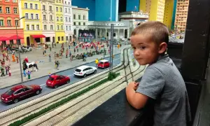 Chłopiec z zaciekawieniem ogląda miniaturową Gliwice. Atrakcje dla dzieci w tym modelu miasta zachwycają detalami.